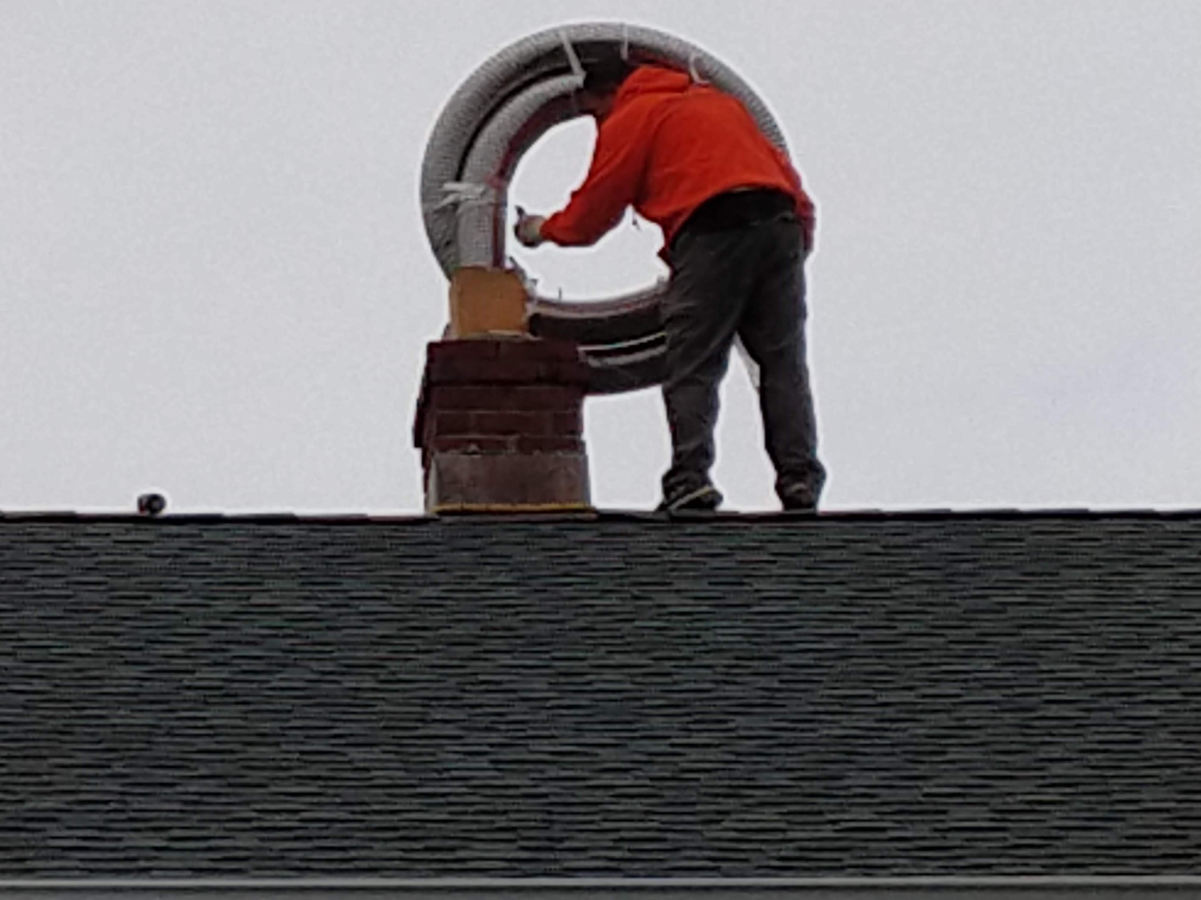 Flexible stainless chimney liner being installed in Roslyn, New York